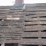 Hand riven planks on east exposure at original phase one chimney. Note joint line of planks up roof on each side of chimney.